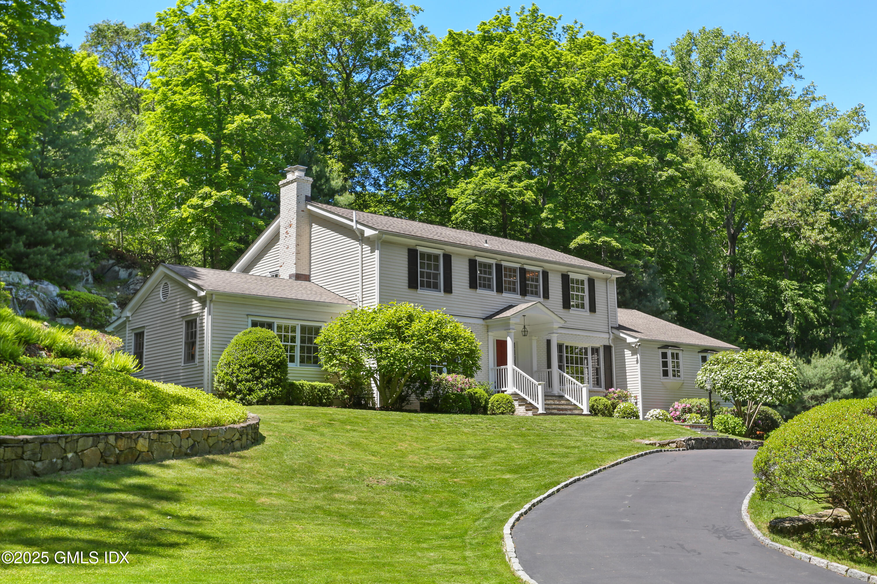 36 Horseshoe Road Cos Cob, CT 06807 - Photo 1 of 39 a front view of a house with a yard