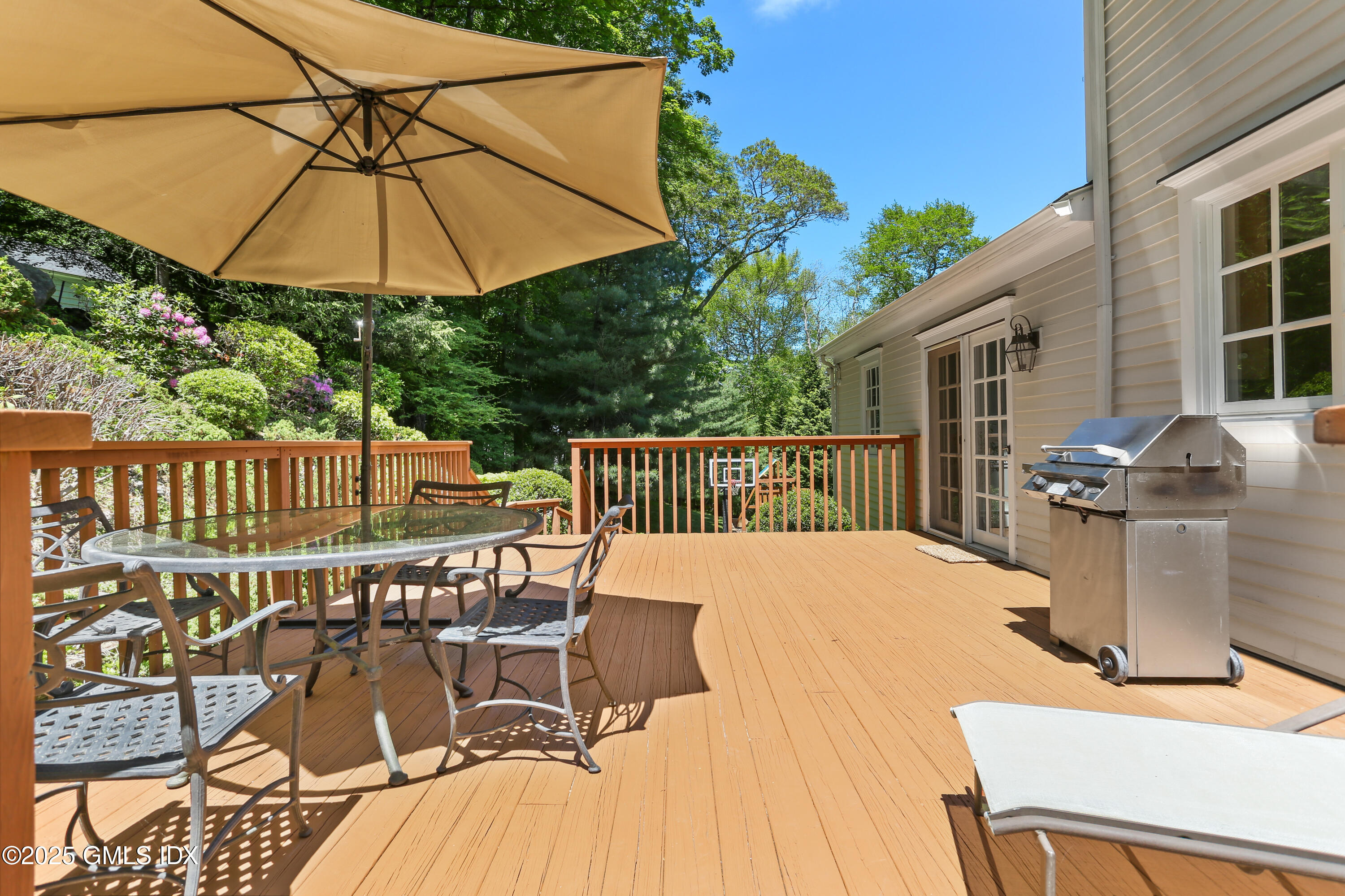 36 Horseshoe Road Cos Cob, CT 06807 - Photo 14 of 39 a view of a patio with a table and chairs under an umbrella