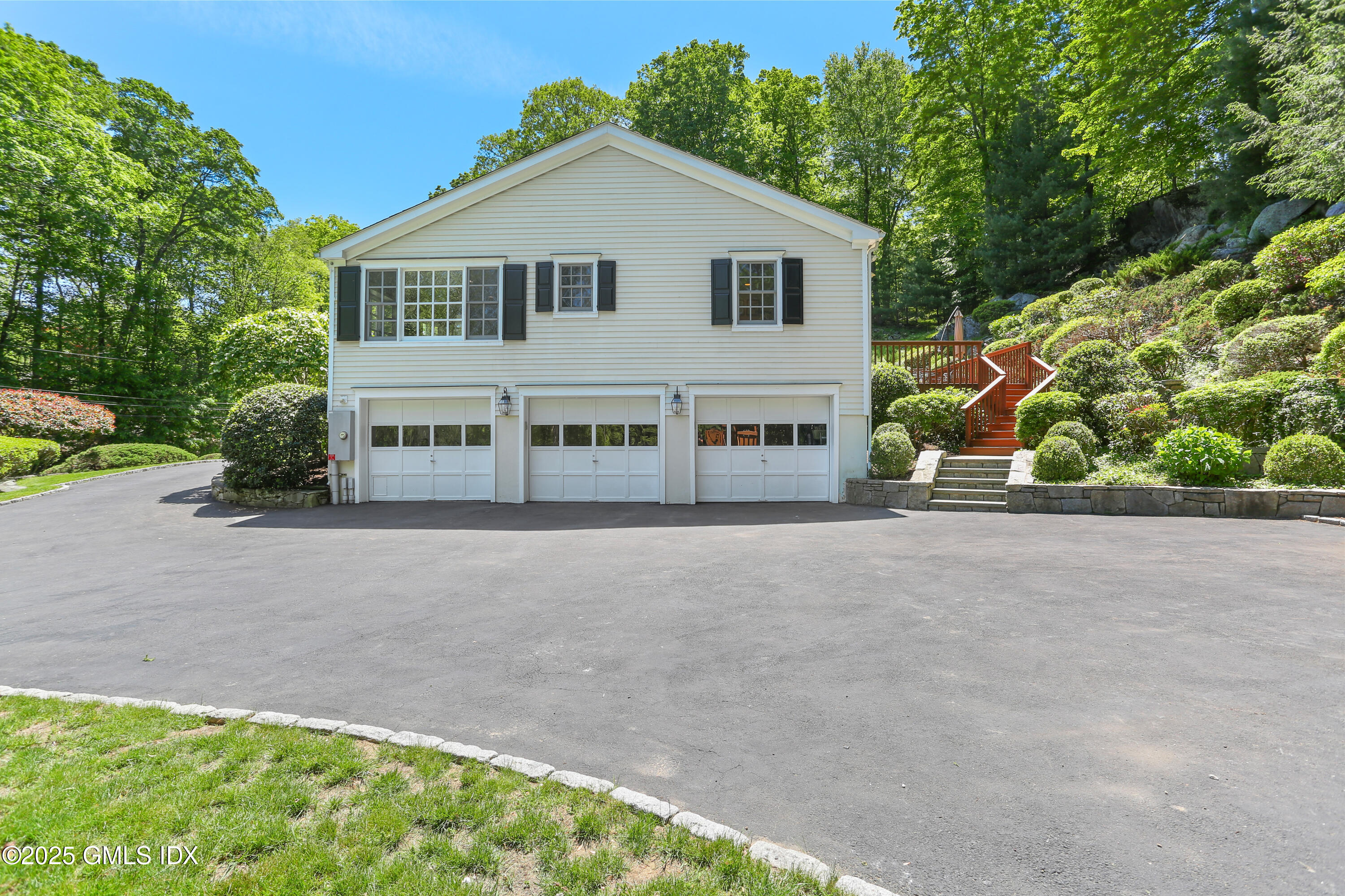 36 Horseshoe Road Cos Cob, CT 06807 - Photo 33 of 39 a front view of a house with a yard and garage