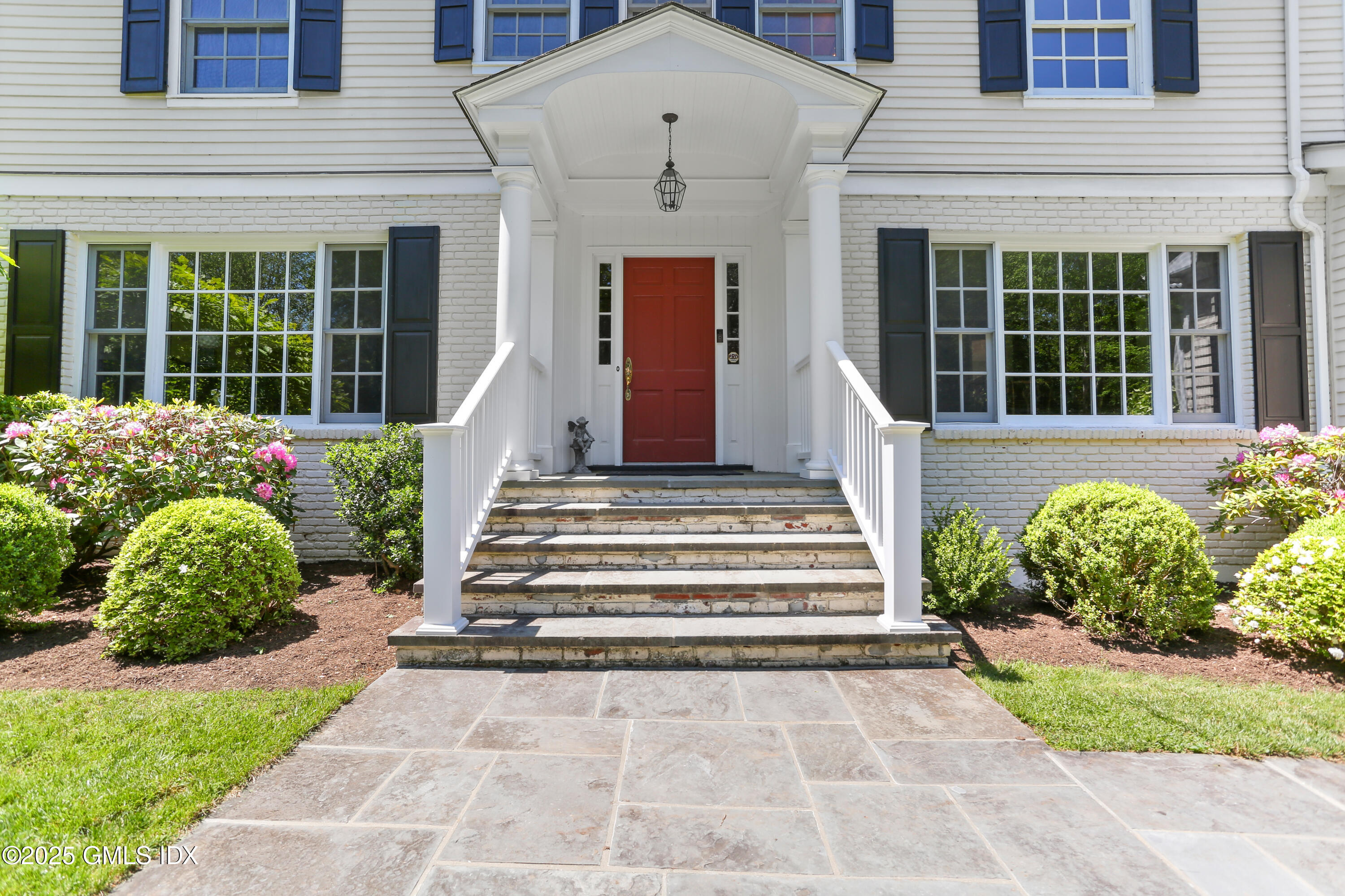36 Horseshoe Road Cos Cob, CT 06807 - Photo 36 of 39 a front view of a house with a garden