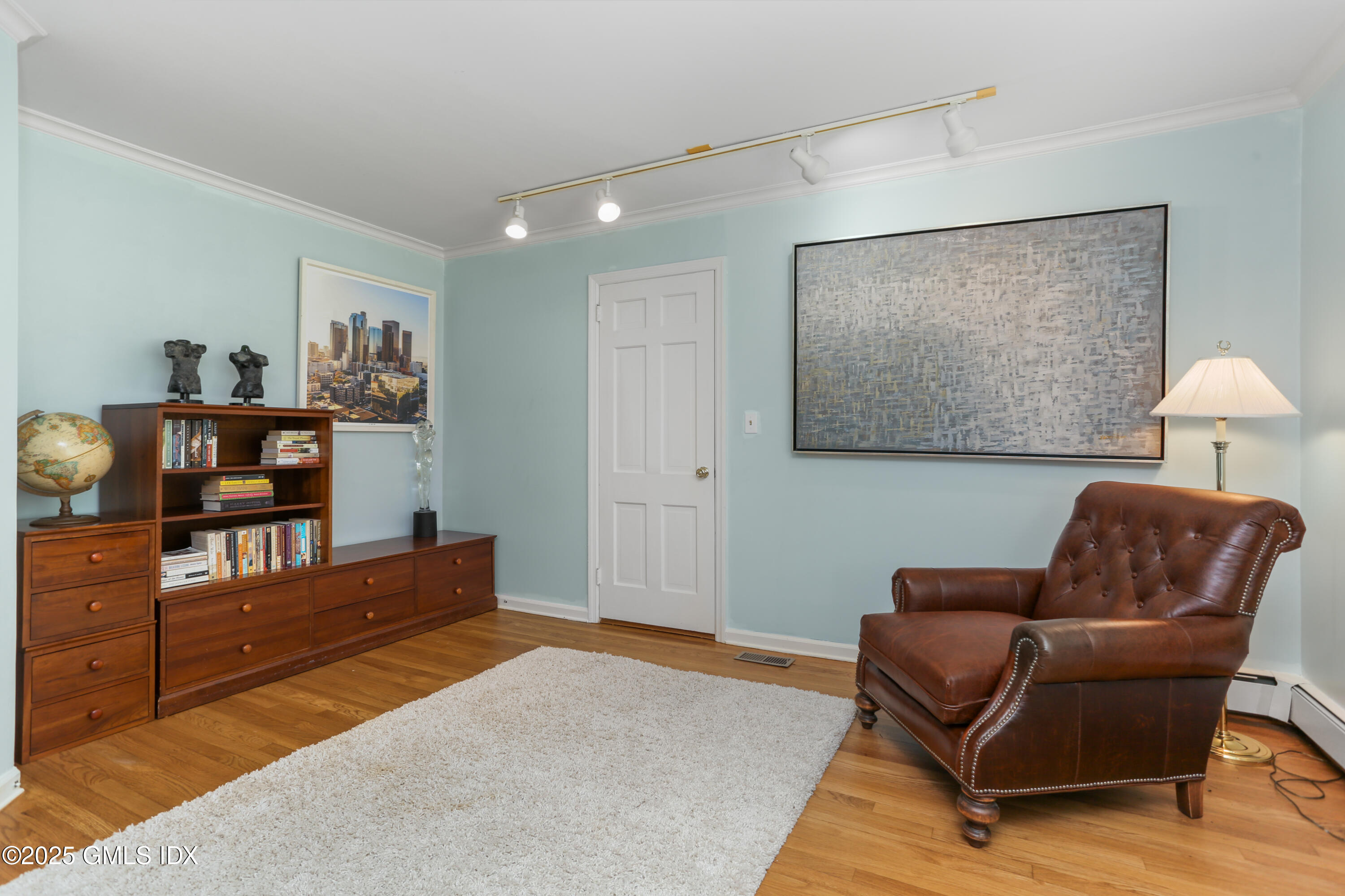 36 Horseshoe Road Cos Cob, CT 06807 - Photo 9 of 39 a living room with furniture and a bookshelf