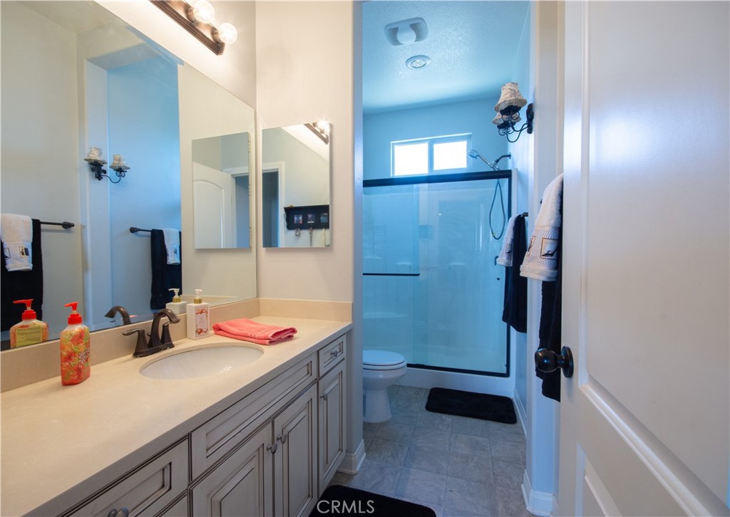 11950 Flicker Cove Corona, CA 92883 - Photo 18 of 28 a bathroom with a sink and a mirror