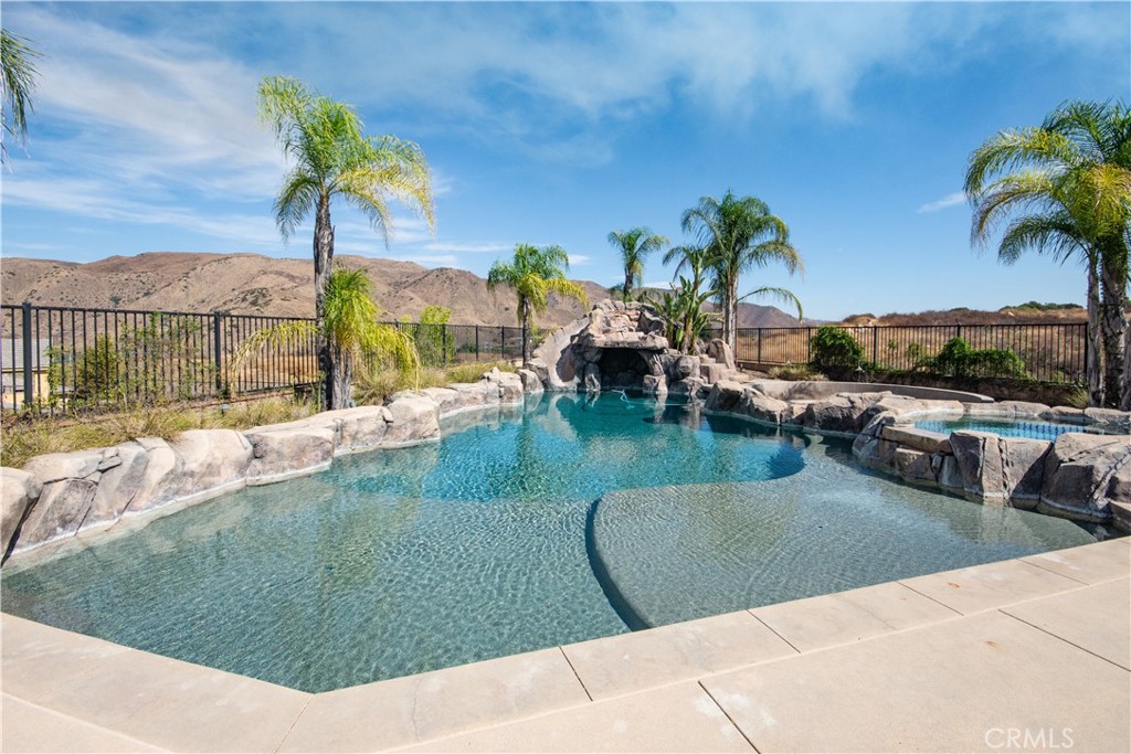 11950 Flicker Cove Corona, CA 92883 - Photo 19 of 28 a view of a swimming pool with a patio