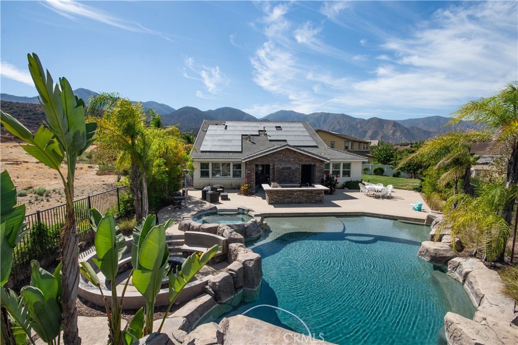 11950 Flicker Cove Corona, CA 92883 - Photo 22 of 28 a view of a house with swimming pool and sitting area