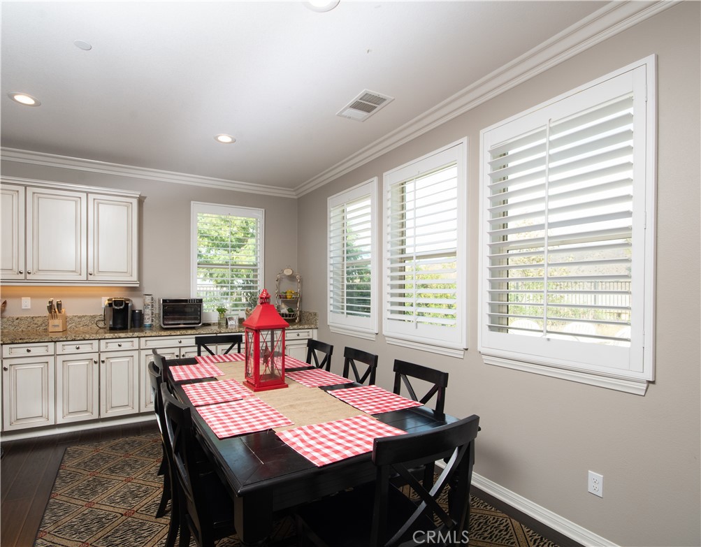 11950 Flicker Cove Corona, CA 92883 - Photo 6 of 28 a view of a dining room with furniture and windows