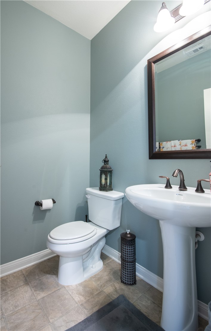 11950 Flicker Cove Corona, CA 92883 - Photo 7 of 28 a bathroom with a toilet sink and mirror