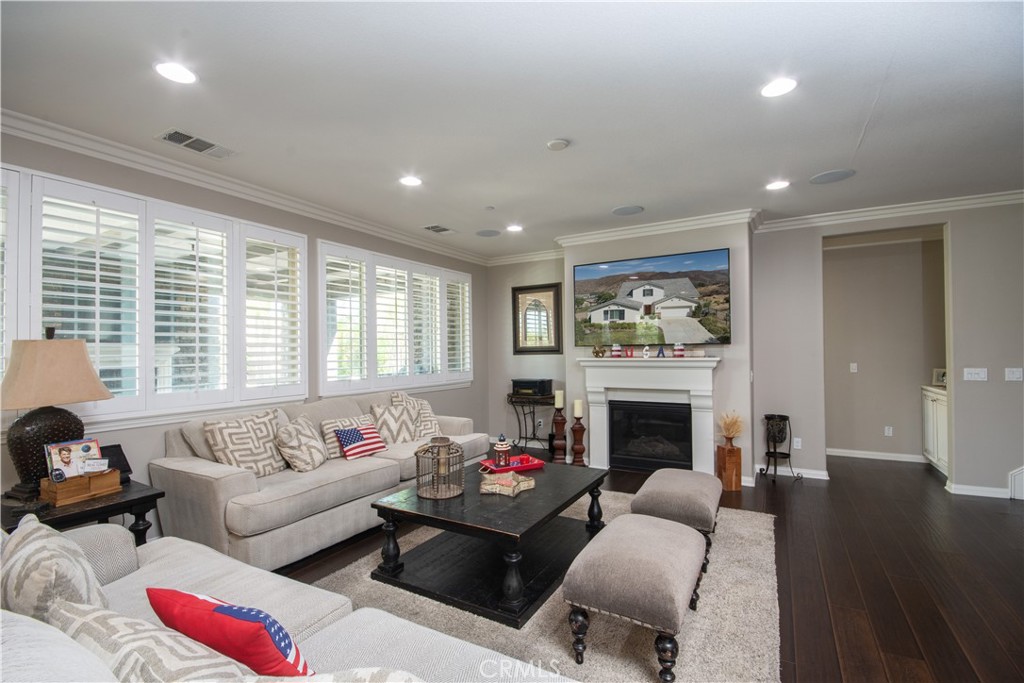 11950 Flicker Cove Corona, CA 92883 - Photo 9 of 28 a living room with furniture fireplace and a large window