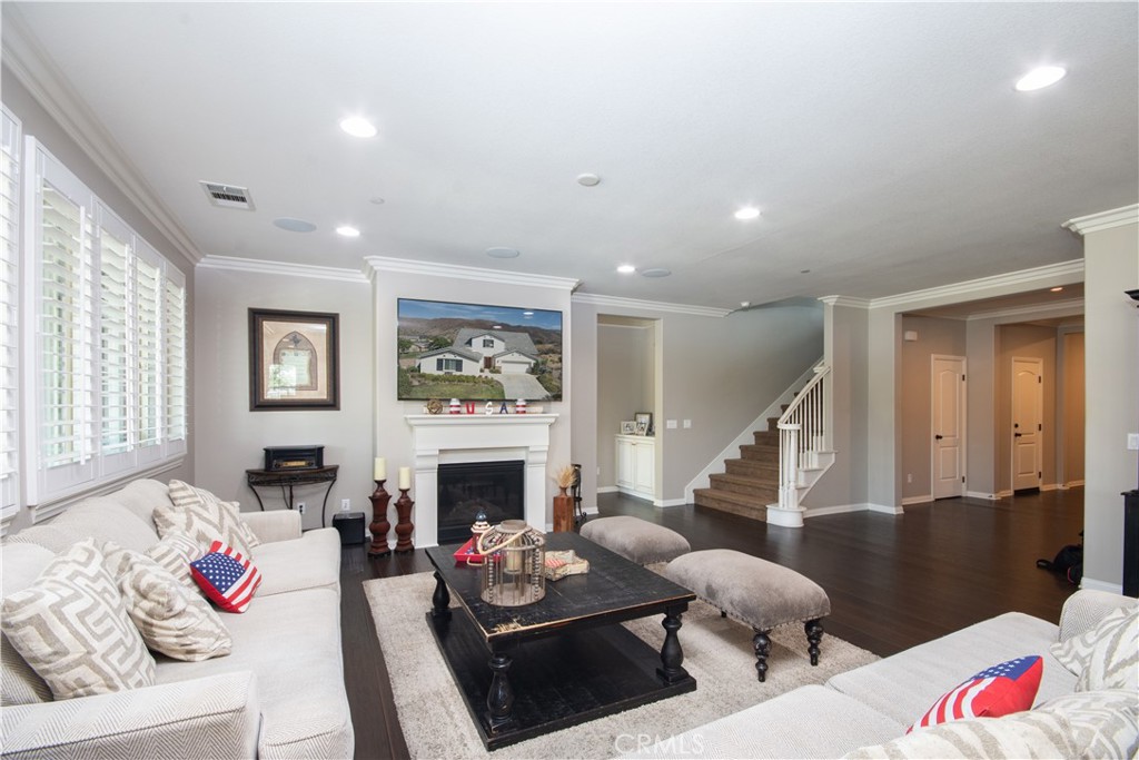 11950 Flicker Cove Corona, CA 92883 - Photo 10 of 28 a living room with furniture fireplace and a window