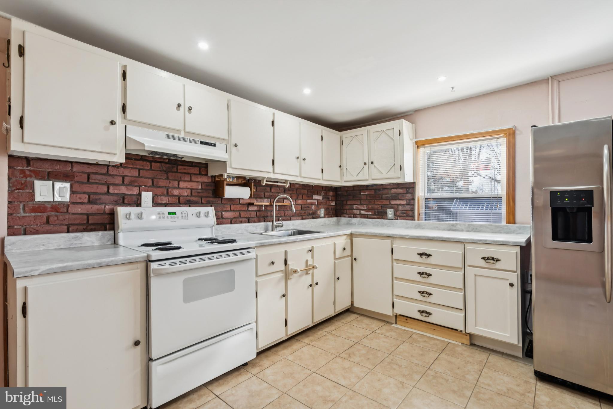 255 South Woodruff Road Bridgeton, NJ 08302 - Photo 11 of 25 a kitchen with cabinets appliances a sink and a window
