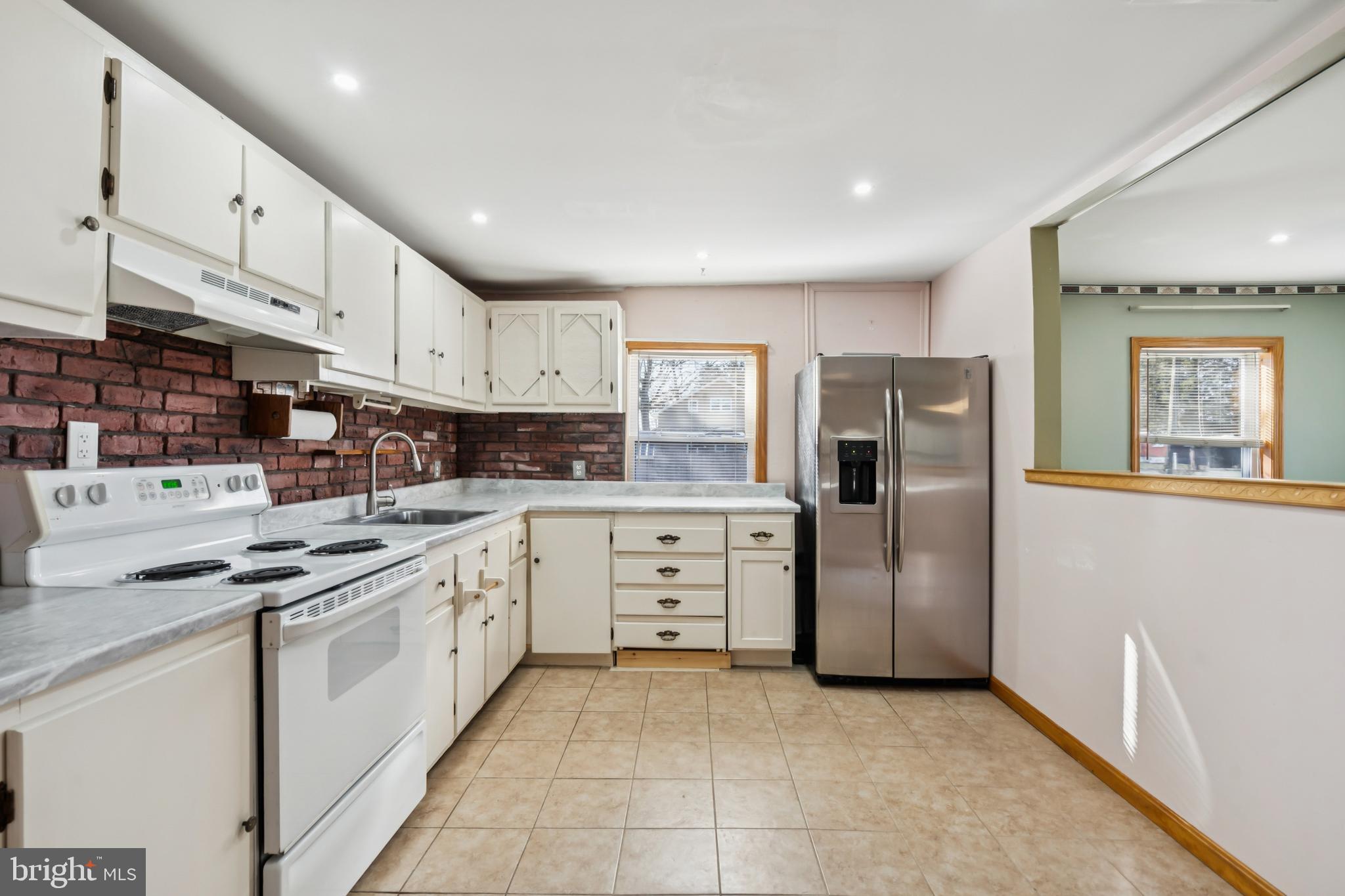 255 South Woodruff Road Bridgeton, NJ 08302 - Photo 9 of 25 a kitchen with white cabinets and stainless steel appliances