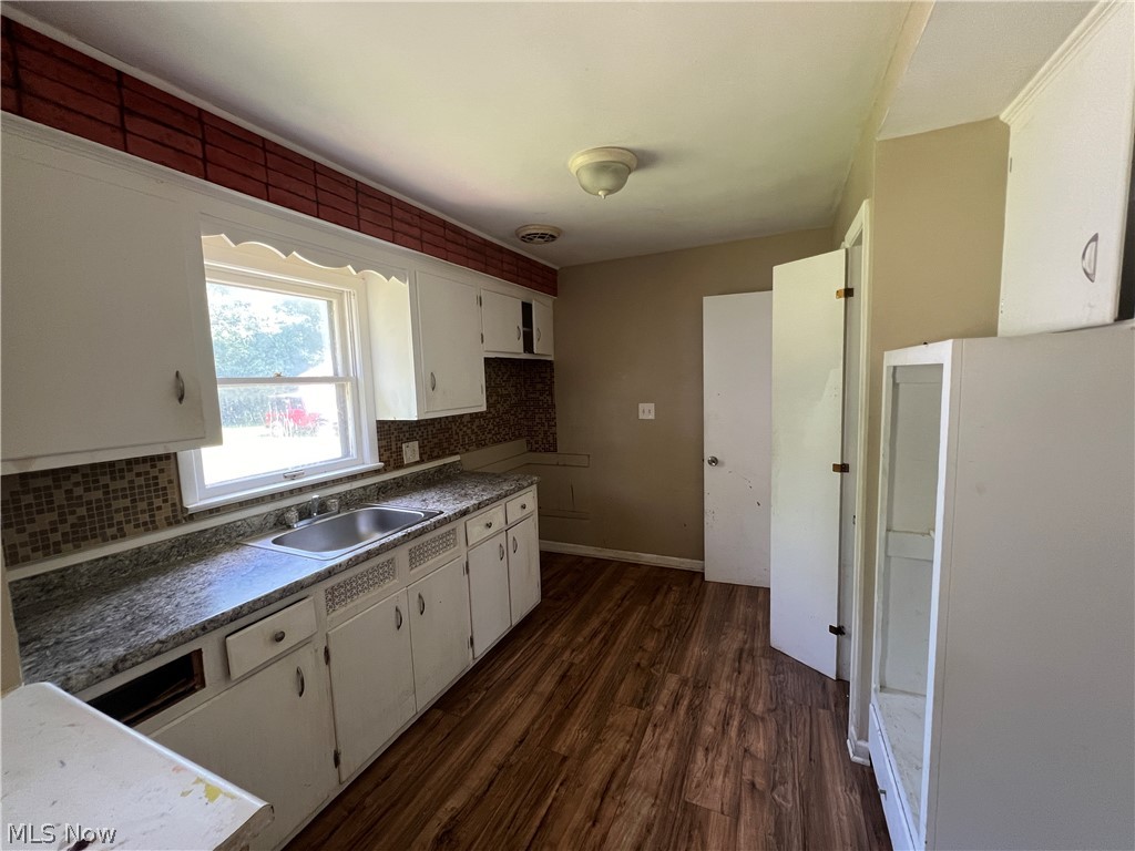 20731 Donnybrook Road Maple Heights, OH 44137 - Photo 2 of 17 Kitchen featuring sink, dark hardwood / wood-style flooring, tasteful backsplash, and white cabinets