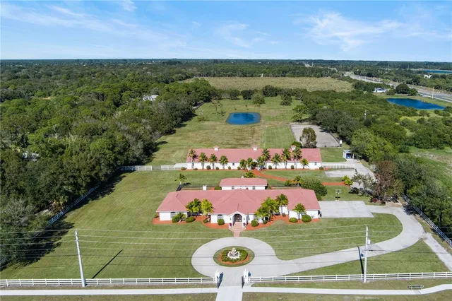 an aerial view of a house with a yard