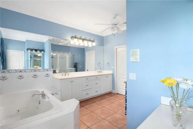 a bathroom with a tub sink and mirror