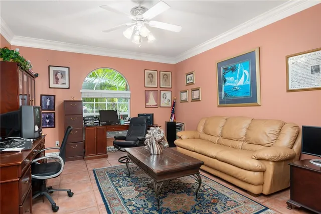 a living room with furniture a flat screen tv and a large window