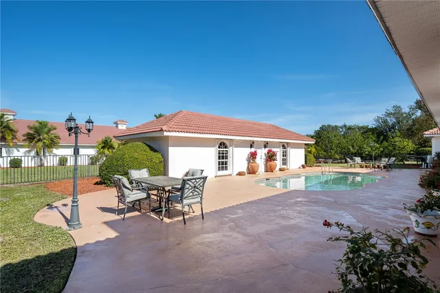 a view of a house with backyard porch and sitting area