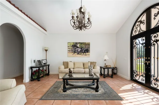 a living room with furniture a rug and a window