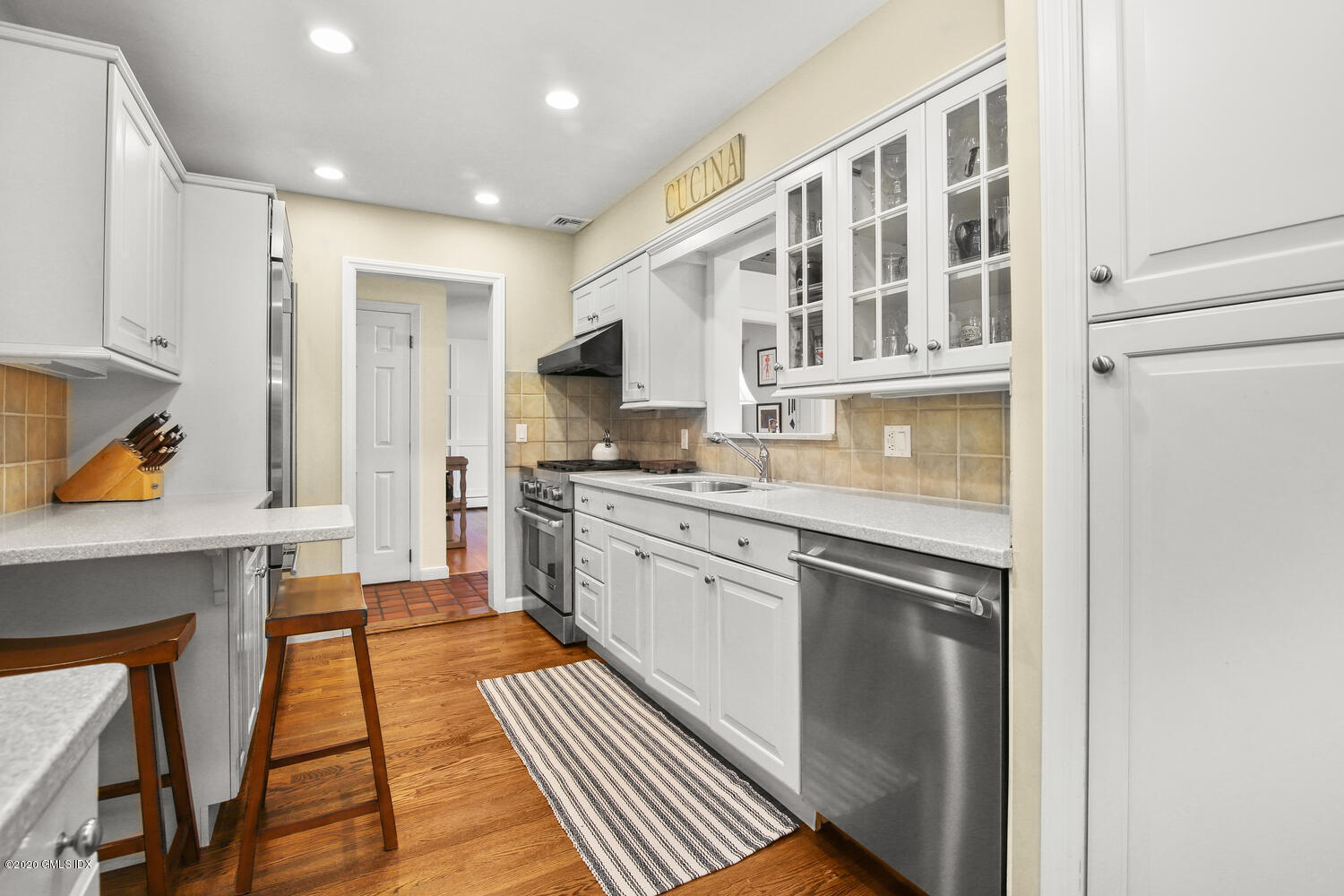 16 Ridge Road Cos Cob, CT 06807 - Photo 11 of 34 a kitchen with stainless steel appliances granite countertop a refrigerator a stove and a sink with cabinets