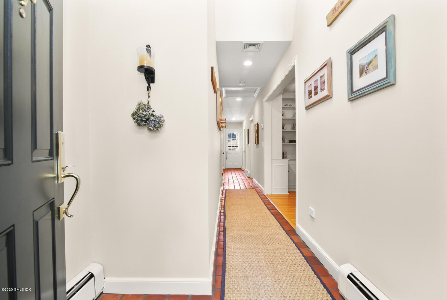 16 Ridge Road Cos Cob, CT 06807 - Photo 3 of 34 a view of a hallway with paintings on the wall
