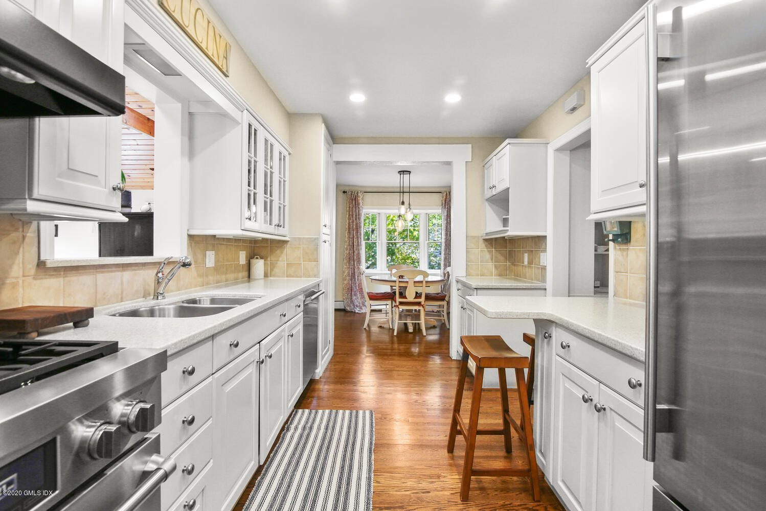 16 Ridge Road Cos Cob, CT 06807 - Photo 9 of 34 a large kitchen with stainless steel appliances a lot of counter space and a window