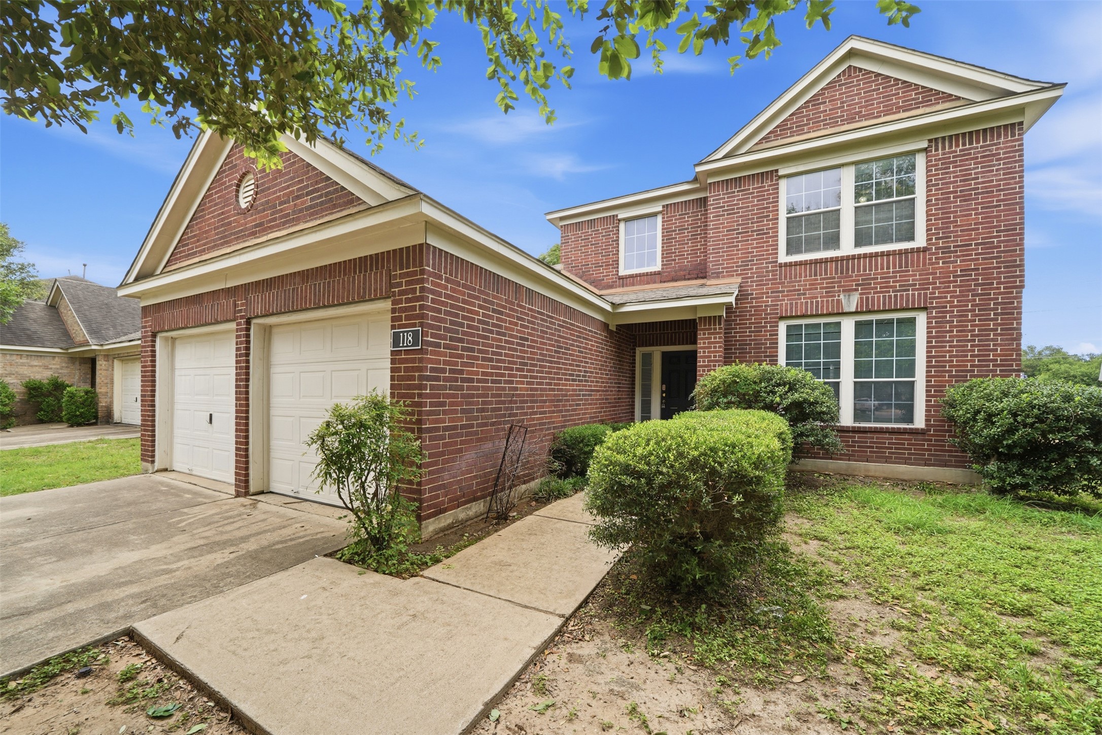 118 Invierno Street Kyle, TX 78640 - Photo 2 of 37 A classic brick facade welcomes you to this inviting two-story residence with an attached garage.