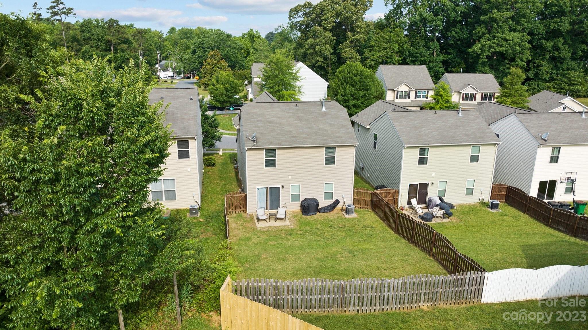 902 Rook Road Charlotte, NC 28216 - Photo 29 of 30 an aerial view of a house with swimming pool and trees
