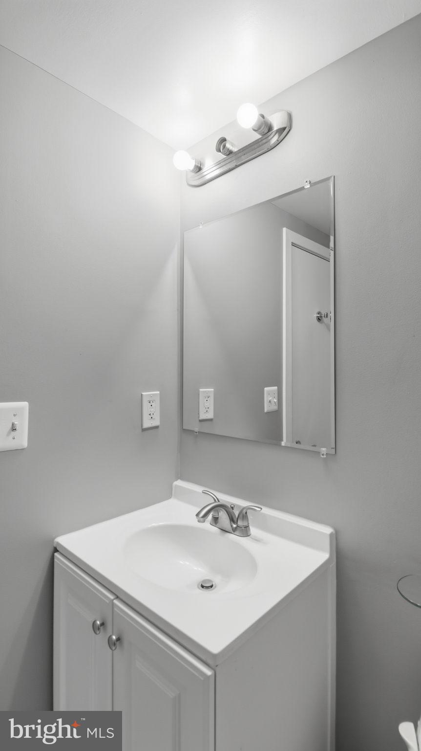2317 16th Street Southeast, Unit 102 Washington, DC 20020 - Photo 21 of 23 a bathroom with a sink and a mirror