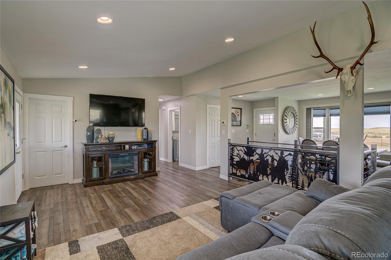 4531 East Best Road Larkspur, CO 80118 - Photo 11 of 49 a living room with furniture and a flat screen tv