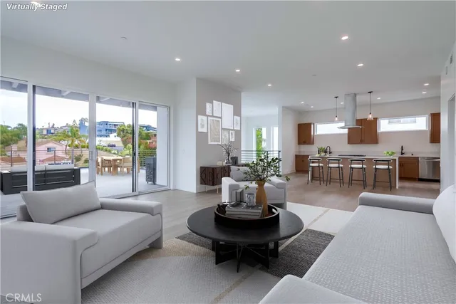 a living room with furniture and kitchen view