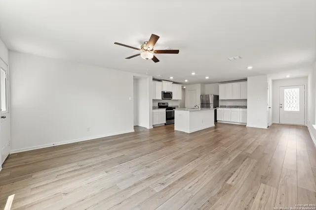 a view of a kitchen with a sink and wooden floor