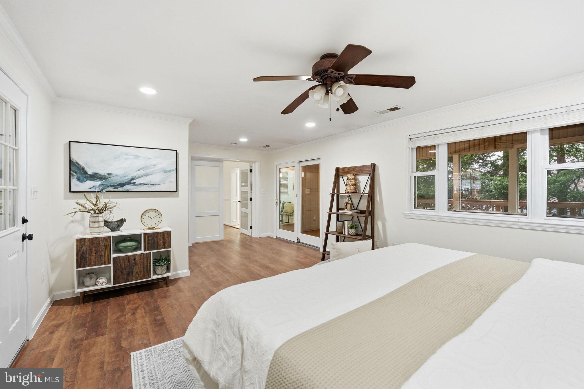 5718 Anola Court Springfield, VA 22151 - Photo 18 of 45 a spacious bedroom with a bed and a flat screen tv