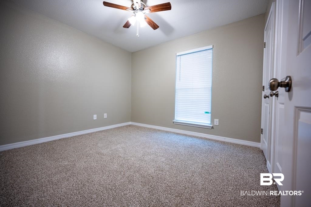 15874 Carver Road, Unit C Foley, AL 36535 - Photo 18 of 18 Carpeted spare room with ceiling fan