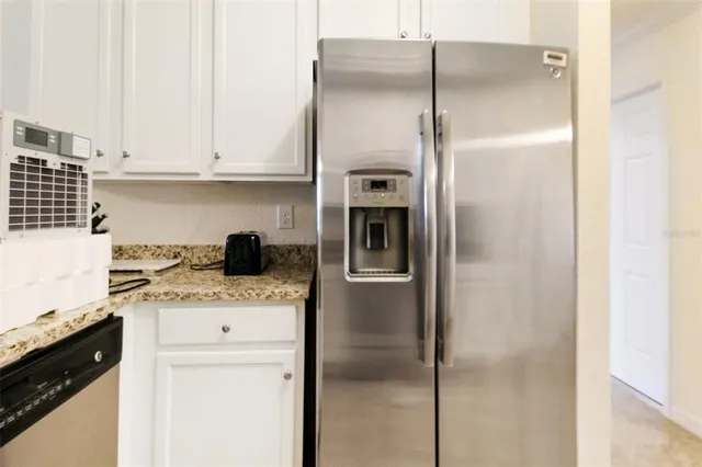 a kitchen with a refrigerator and cabinets