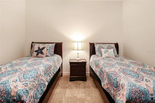 a bedroom with double bed and a lamp