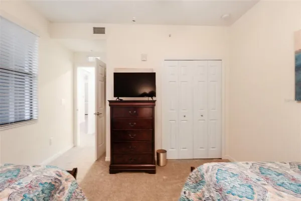 a bedroom with a bed and a television