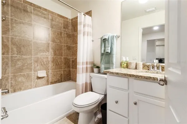 a bath tub sitting next to a white sink