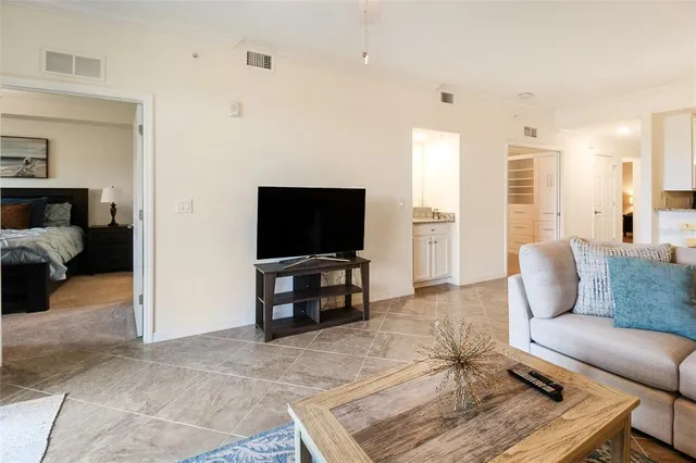 a living room with pool table and chairs
