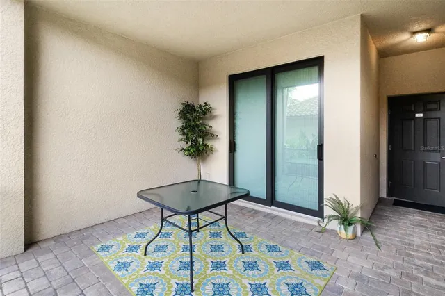a room with painting and a potted plant