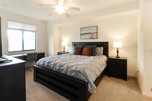 a bedroom with a bed and a lamp