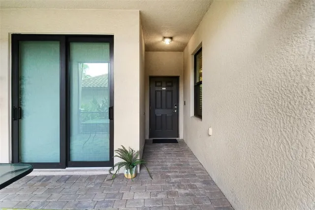 a view of a hallway with wooden walls and a glass door