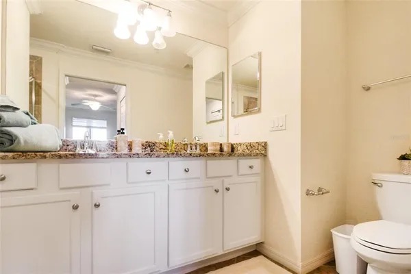 a bathroom with a granite countertop sink a mirror and a shower