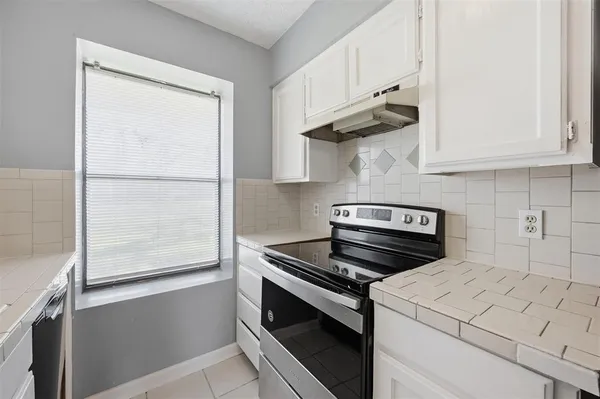 a kitchen with a stove and a refrigerator