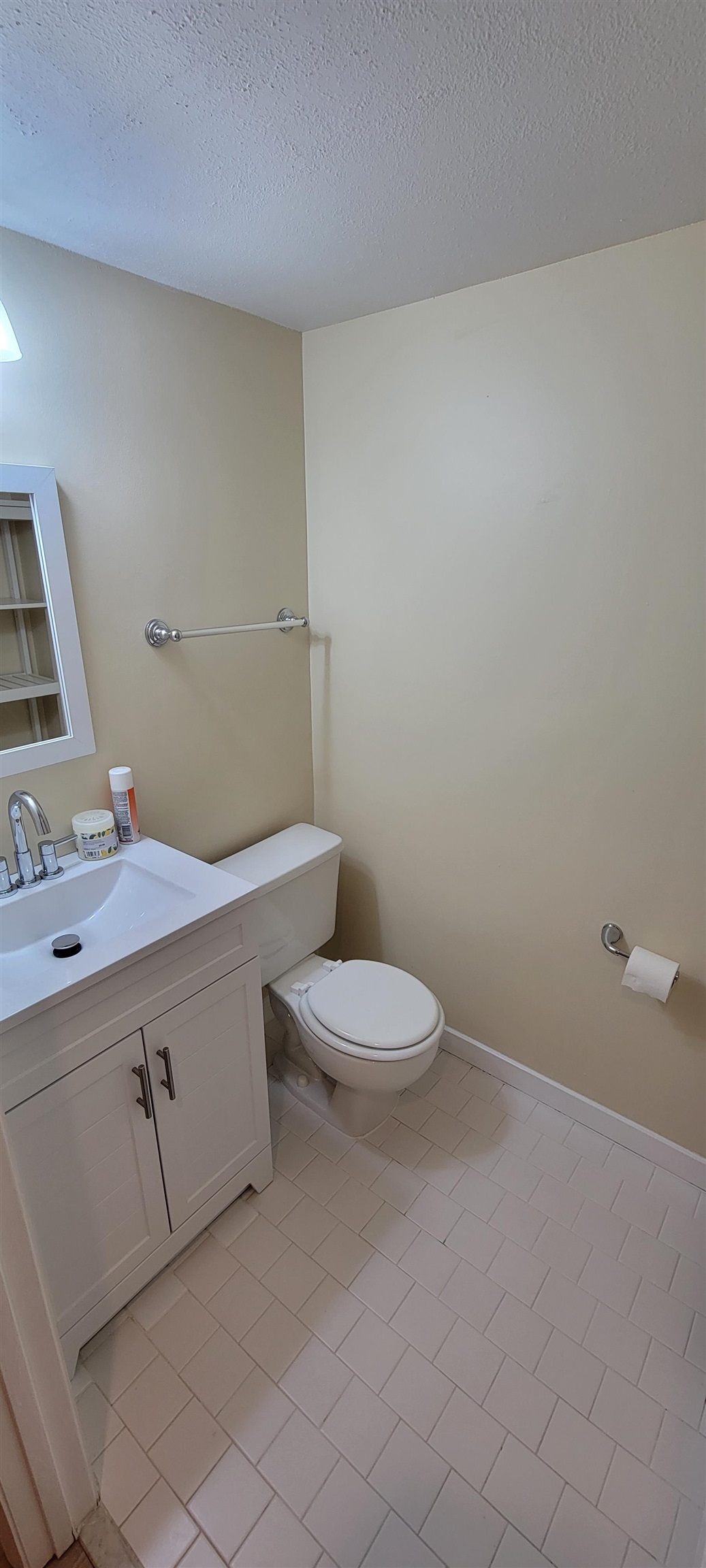 5 Catalonia Court St. Augustine, FL 32086 - Photo 13 of 30 Bathroom featuring vanity, a textured ceiling, and light tile patterned floors