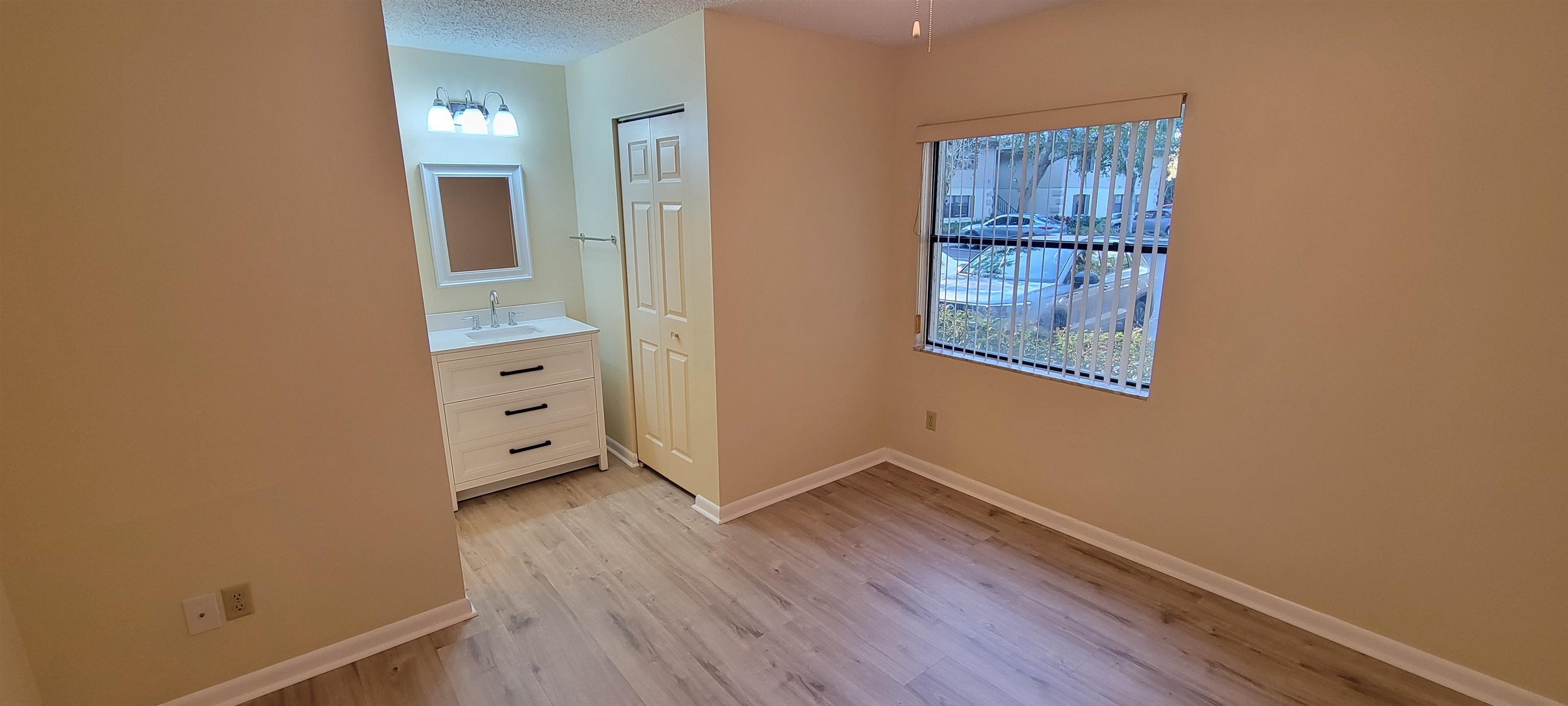 5 Catalonia Court St. Augustine, FL 32086 - Photo 15 of 30 Unfurnished bedroom with light wood finished floors, a textured ceiling, and a closet