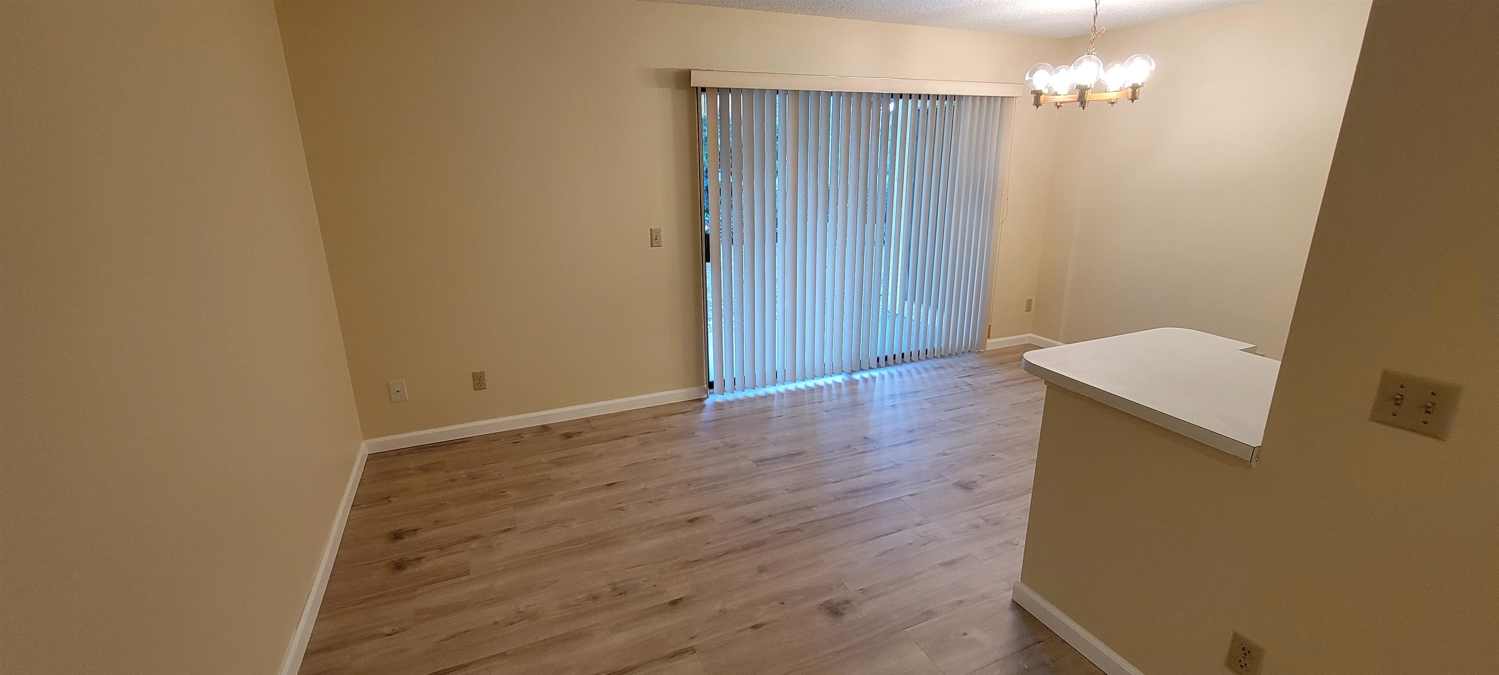 5 Catalonia Court St. Augustine, FL 32086 - Photo 20 of 30 Spare room featuring light wood finished floors and a chandelier