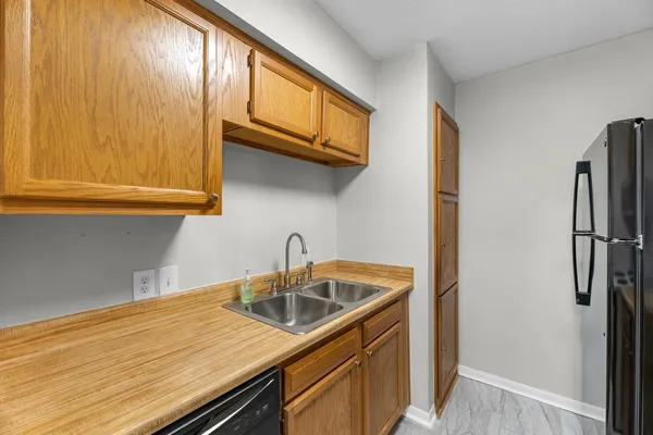 a kitchen with kitchen island a sink cabinets and stainless steel appliances