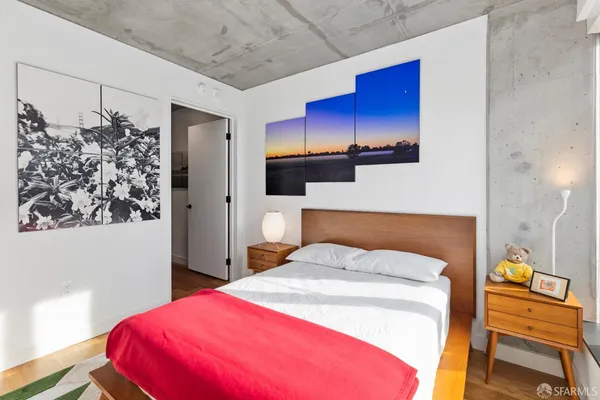 a bedroom with a bed potted plant on the dresser and a potted plant