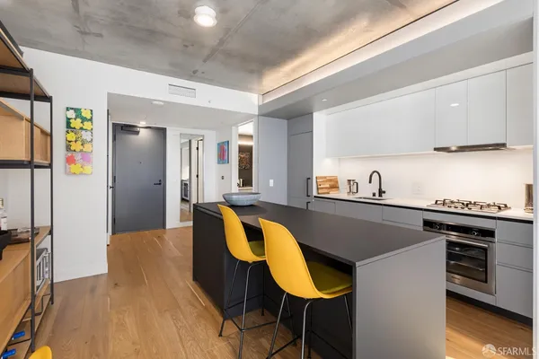 a kitchen with a table chairs and a refrigerator
