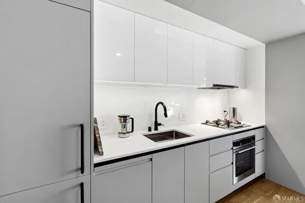 a kitchen with a sink and a stove top oven