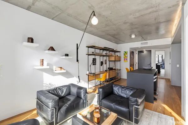 a living room with furniture and a wooden floor