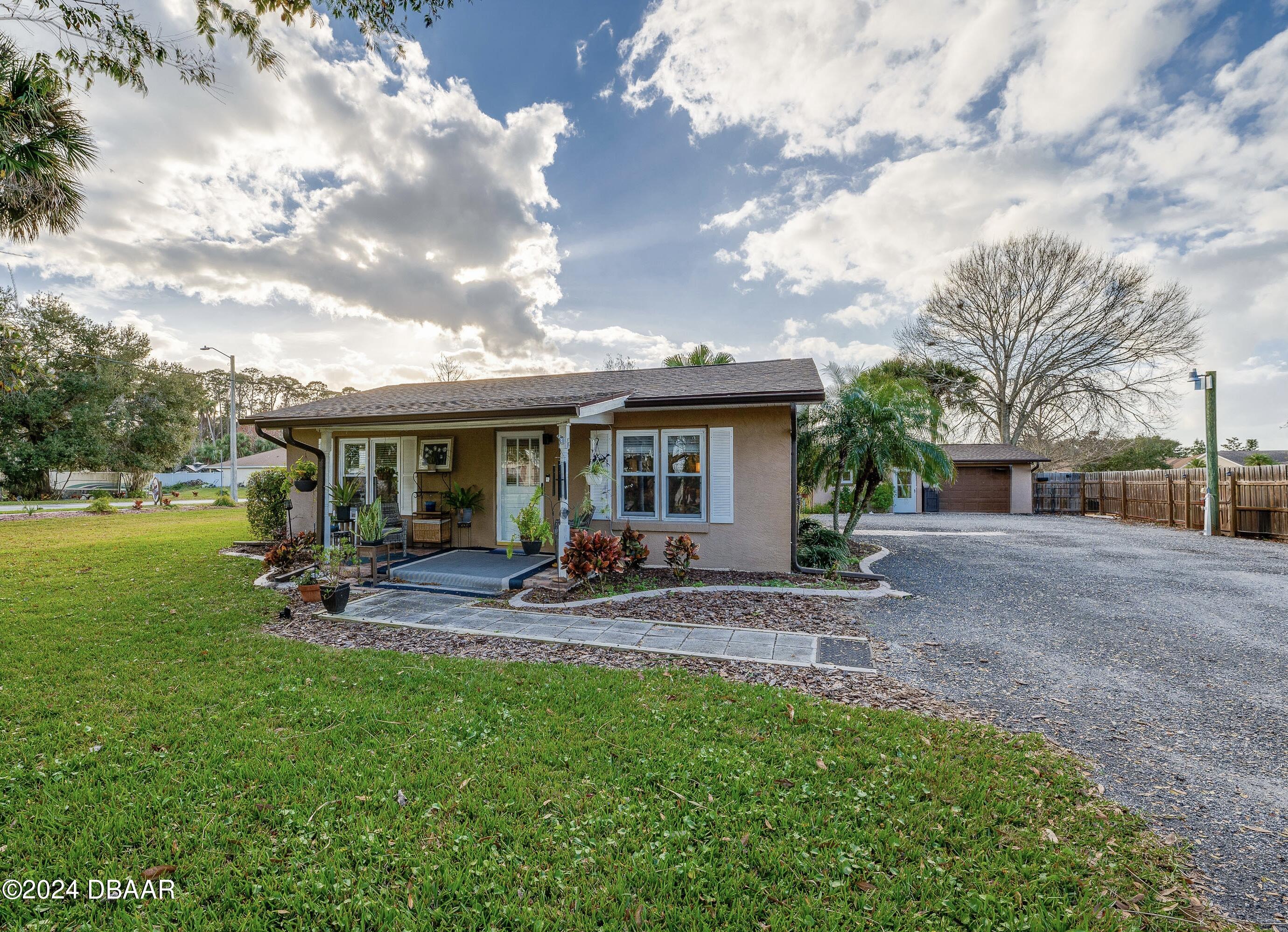 4850 Spruce Creek Road Port Orange, FL 32127 - Photo 1 of 27 a view of a house with backyard porch and sitting area